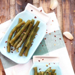 Spicy Garlic & Dill Pickled Green Beans are lacto-fermented with fresh herbs. Serve on a charcuterie plate, add to Bloody Marys or give as a gift.